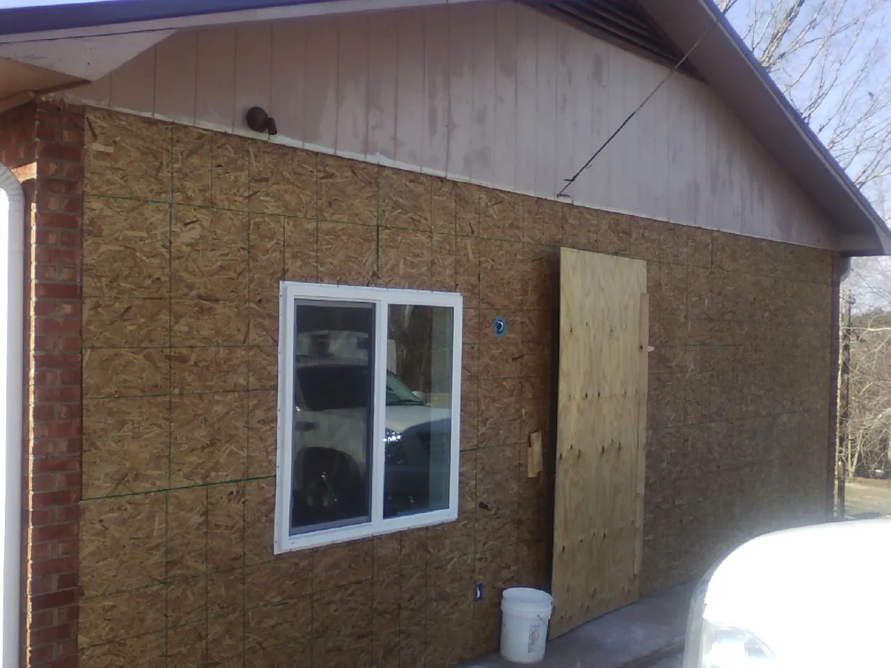 OSB sheathing on a garage addition wall before siding in Shade Gap