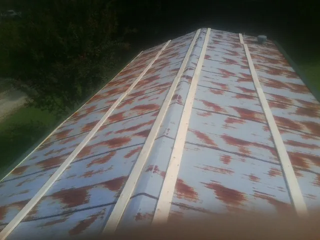 Rusted metal roof panels with new wood purlins before replacement — Storm Damage Roof Repair in Shade Gap by Roofing Brothers